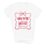 Load image into Gallery viewer, A white short-sleeve crewneck t-shirt with a red graphic print on the front. The graphic features a wavy rectangular border with a bow at the top and the text 'GOING TO THE Chapel GONNA GET Married' in red lettering.