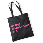 Load image into Gallery viewer, Black tote bag with pink text 'in my bookworm era' on a white background