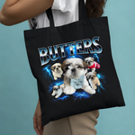 Load image into Gallery viewer, Black tote bag with 'Butters' and images of puppies on a blue background