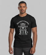 Load image into Gallery viewer, Man wearing a black t-shirt with a graphic design and text on a gray background