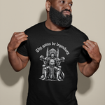 Load image into Gallery viewer, Man wearing a black t-shirt with a graphic design and text against a beige background