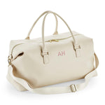 Load image into Gallery viewer, A beige leather duffel bag with a zipper closure and two handles.