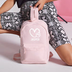 Load image into Gallery viewer, a woman sitting on the floor with a pink backpack