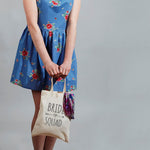 Load image into Gallery viewer, Woman holding a natural Bride Squad mini tote bag