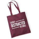 Load image into Gallery viewer, a red bag that says easily distracted by dogs