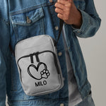 Load image into Gallery viewer, a man wearing a backpack with a heart and paw on it