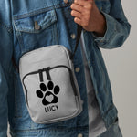 Load image into Gallery viewer, a person wearing a backpack with a dog paw on it