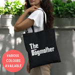 Load image into Gallery viewer, a woman carrying a black tote bag with the slogan the dogmother