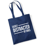Load image into Gallery viewer, a blue bag that says easily distracted by dogs