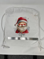 Load image into Gallery viewer, Personalised Santa drawstring bag laid flat beside a ruler to show its size
