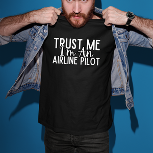 a man holding up a t - shirt that says trust me i'm an