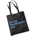 Load image into Gallery viewer, Black tote bag with blue text &#39;in my bookworm era&#39; on a white background
