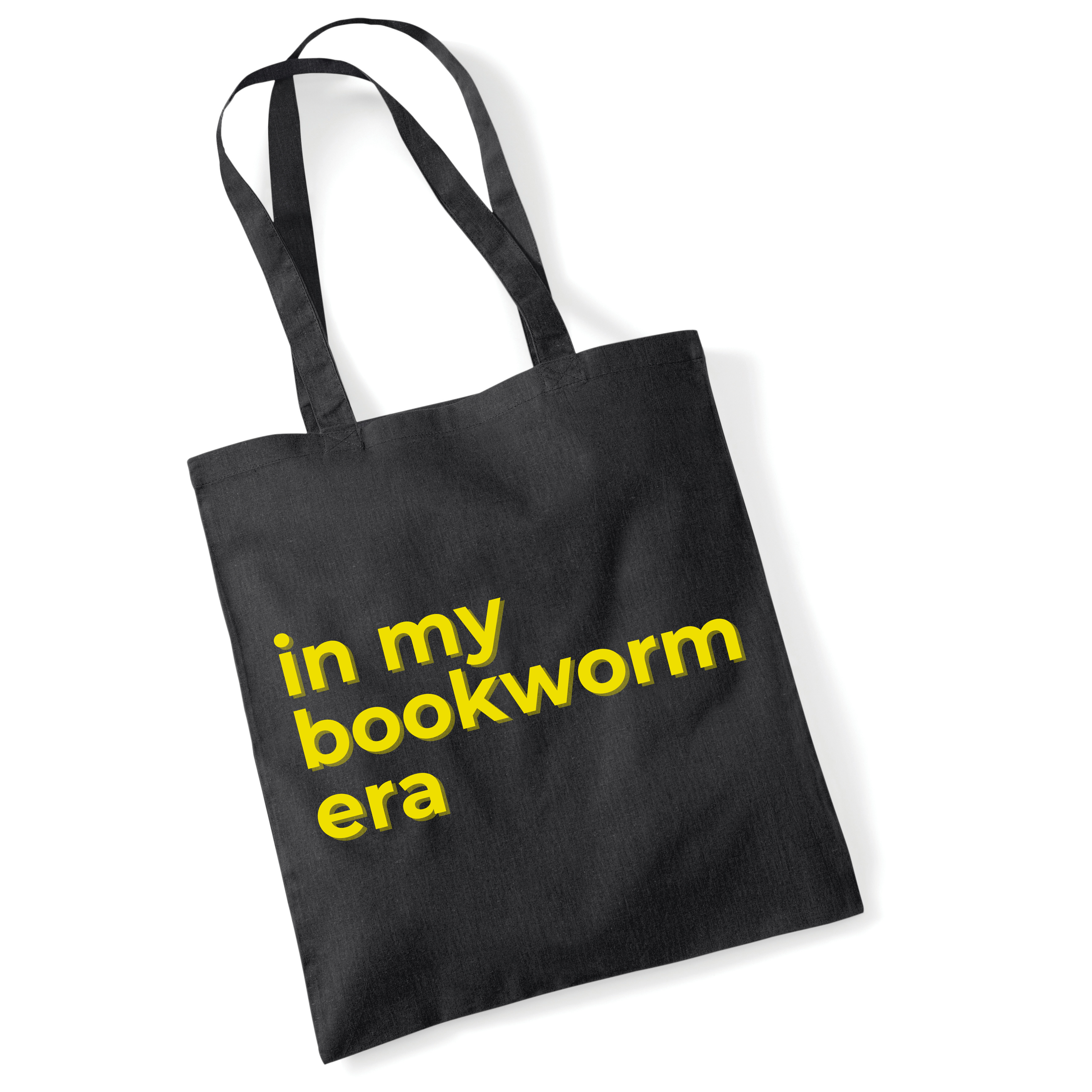 Black tote bag with yellow text 'in my bookworm era' on a white background