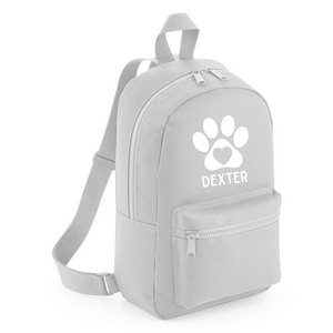 a gray backpack with a white dog paw on it
