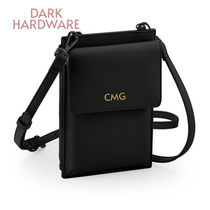 A black crossbody bag with a gold "CMG" logo on the front pocket.
