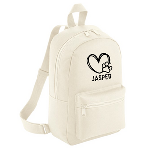 a white backpack with a dog's paw on it