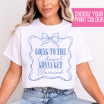 Load image into Gallery viewer, A woman wearing a white graphic T-shirt with a blue line-art frame, bow, and the text 'GOING TO THE Chapel GONNA GET Married.' A pink banner in the top right says 'CHOOSE YOUR PRINT COLOUR.
