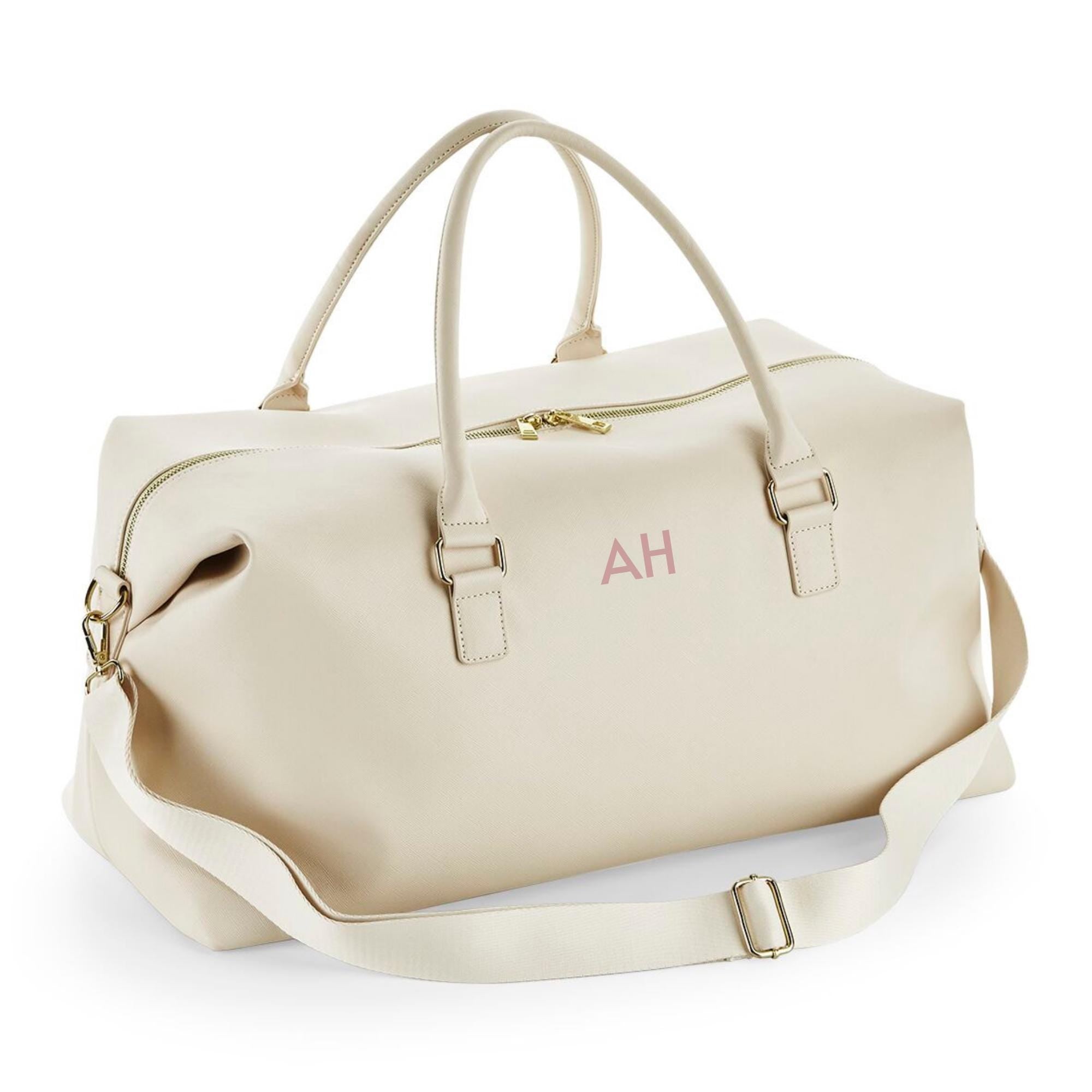 A beige leather duffel bag with a zipper closure and two handles.