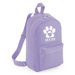 a purple backpack with a white dog paw on it