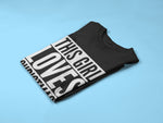 Load image into Gallery viewer, Folded black This Girl Loves Christmas T-shirt with white print
