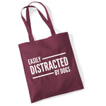 Load image into Gallery viewer, a red bag that says easily distracted by dogs
