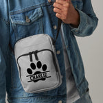 Load image into Gallery viewer, a person wearing a jean jacket holding a white bag with a dog paw on it
