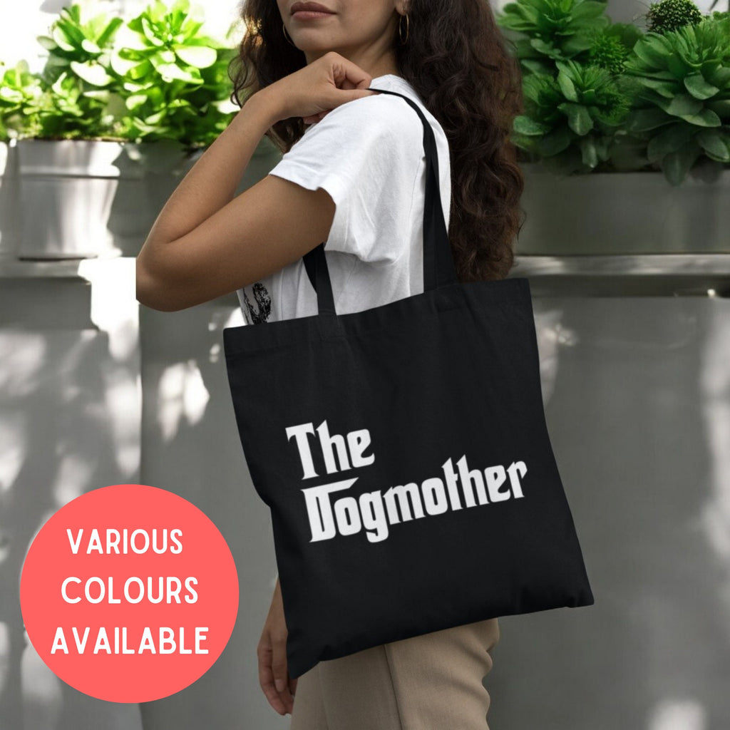 a woman carrying a black tote bag with the slogan the dogmother