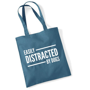 a blue bag that says easily distracted by dogs