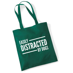 a green bag that says easily distracted by dogs