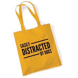 a yellow bag that says easily distracted by dogs