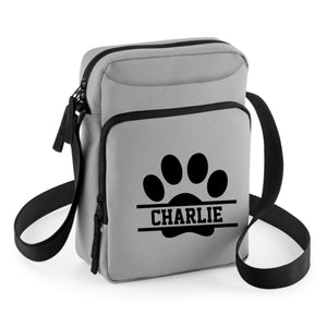 a grey bag with a black dog paw on it
