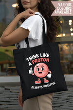 Load image into Gallery viewer, Woman carrying a black Think Like a Proton cotton tote bag over her shoulder
