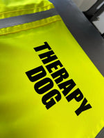 Load image into Gallery viewer, Close-up of yellow Therapy Dog hi vis dog vest with bold black text and reflective strip
