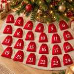 Load image into Gallery viewer, Reusable Advent calendar drawstring bags – 24 red numbered bags laid out under a Christmas tree
